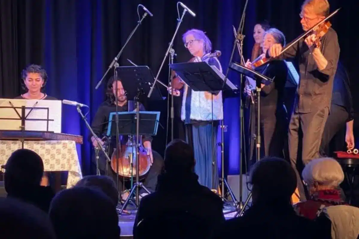 Adelaide Baroque string players performing on stage with santur and double bass in the background