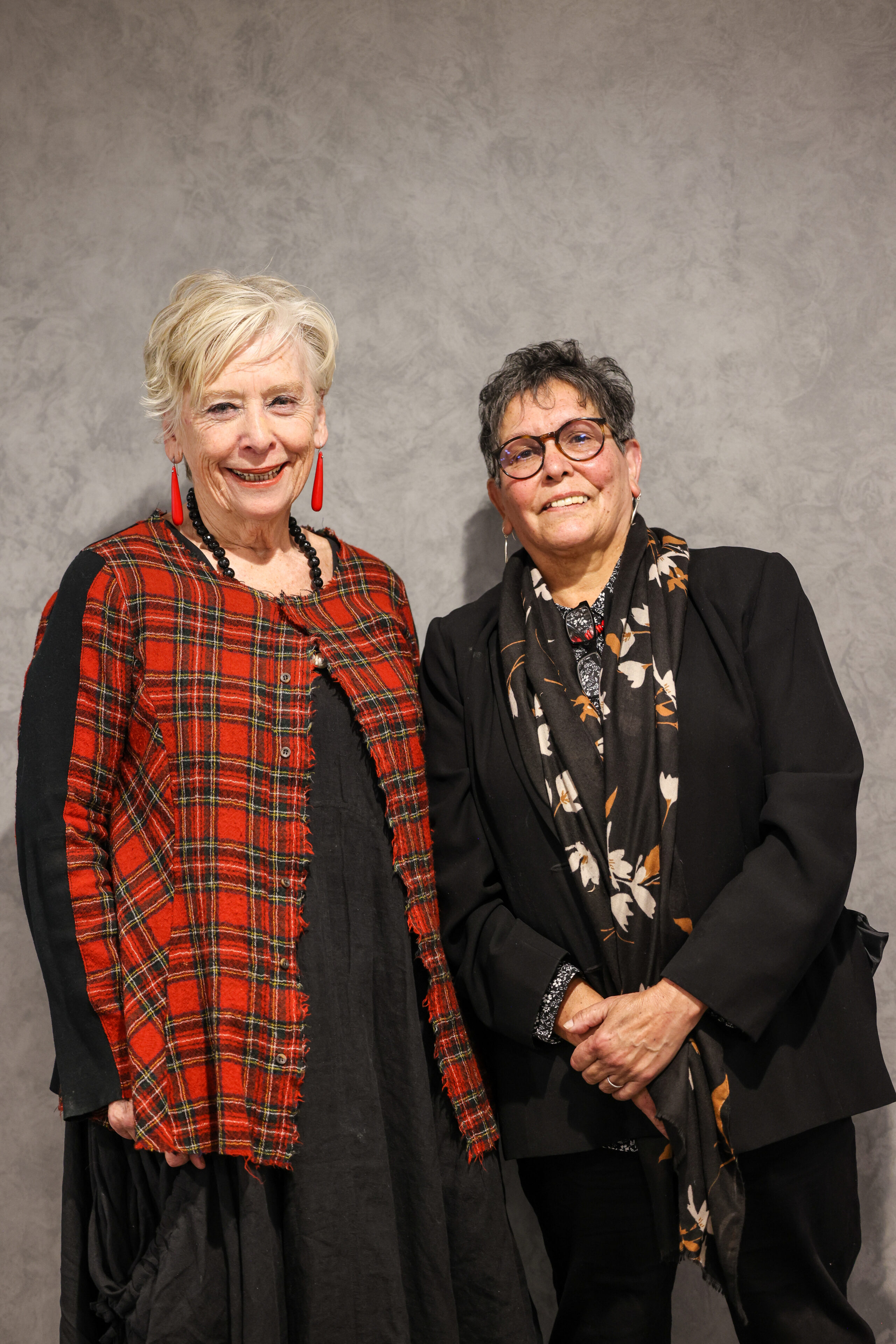 Two older women facing the camera and smiling.
