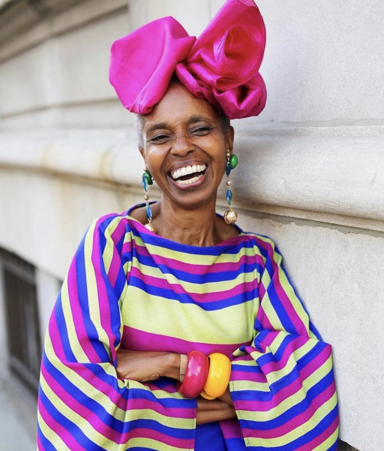 Woman wears colourful clothes as she smiles big