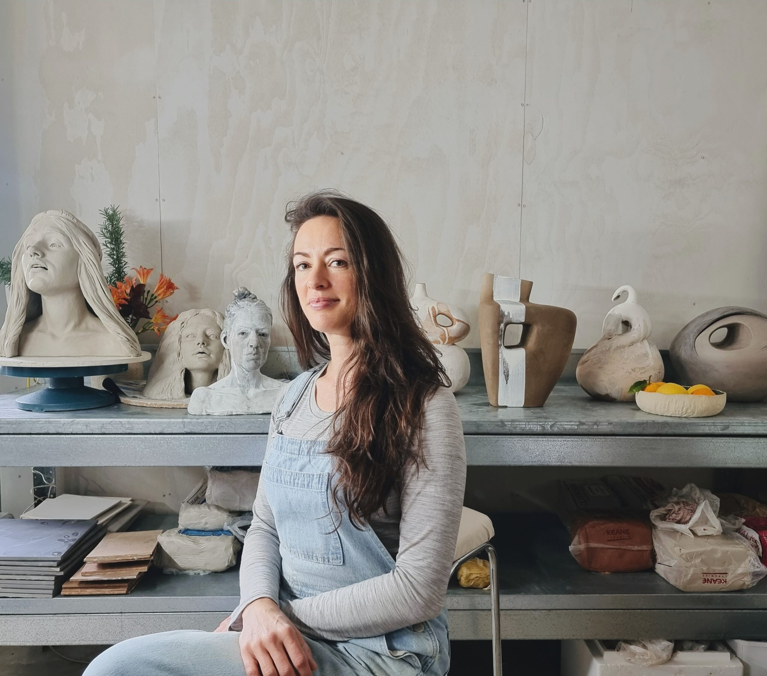 Artist, Alex Linden, sits in her studio.