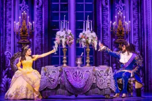 A scene from Beauty and the Beast at the Broadway Theatre, showcasing vibrant costumes and enchanting stage design.