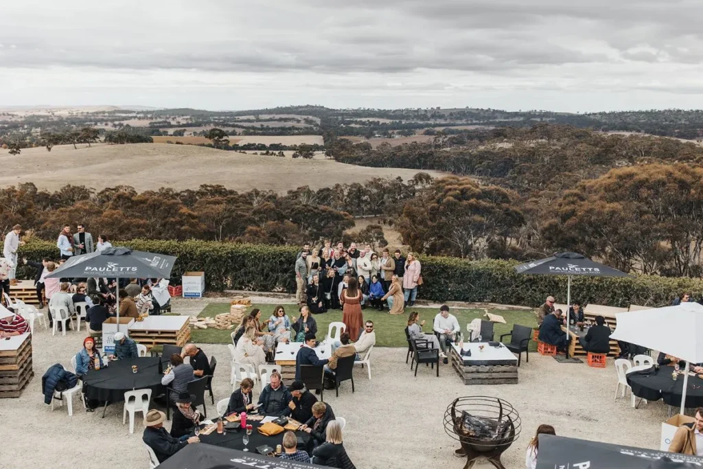 Guests enjoying the scenic view of rolling hills in the background.