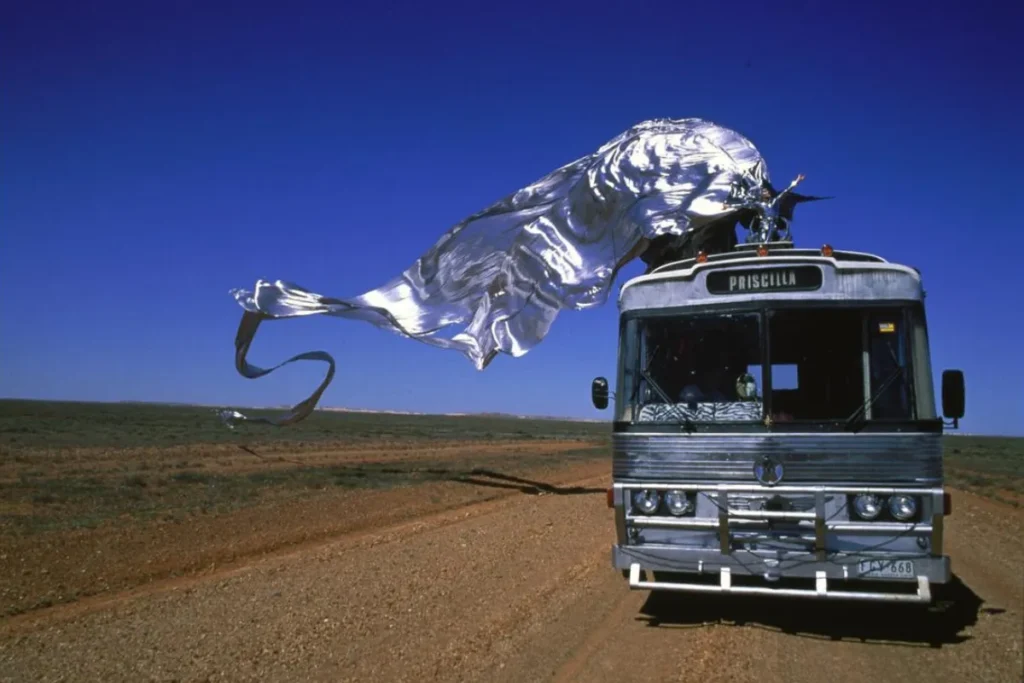 A bus with a large silver sheet billowing above it, creating a dramatic visual effect.