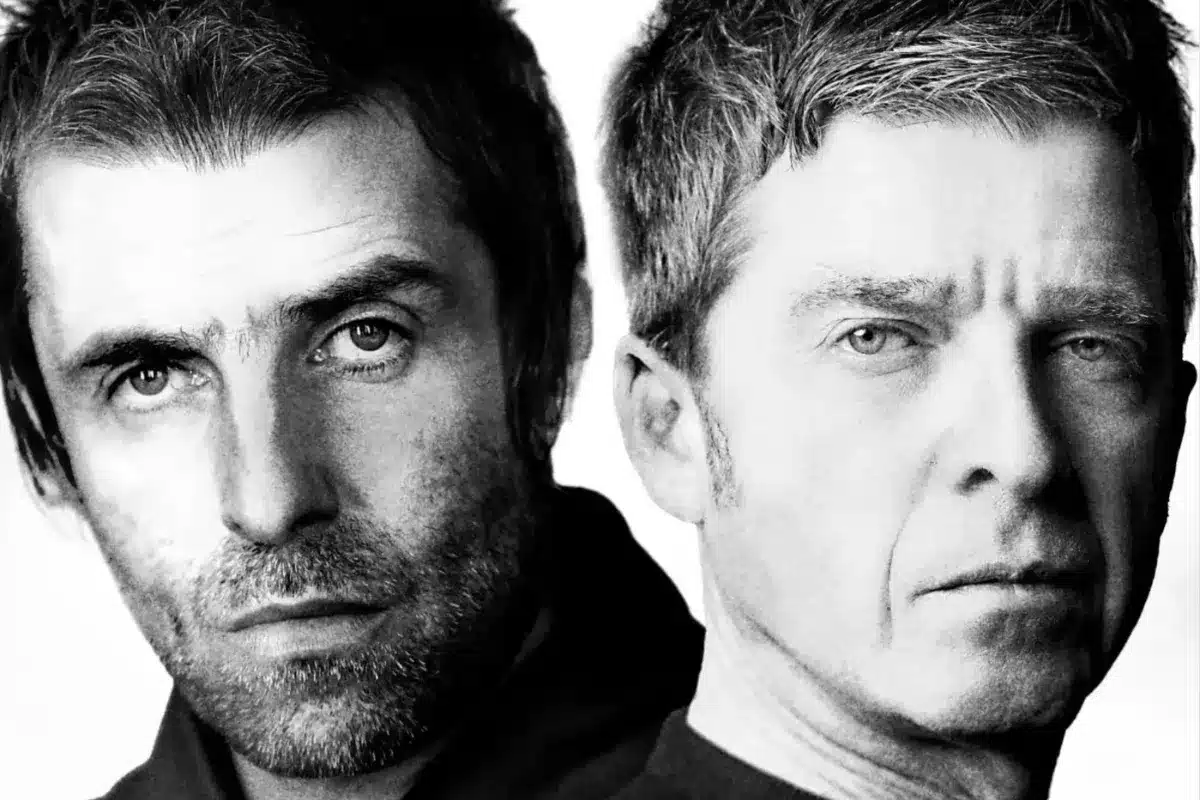 Two men with distinct styles; one man is looking directly at the camera while the other gazes off to the side.