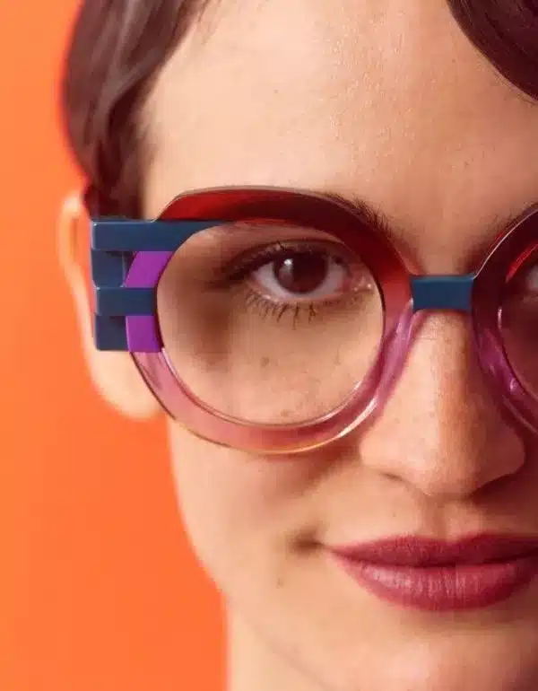Close-up of a woman wearing glasses, showcasing her thoughtful expression and stylish eyewear.