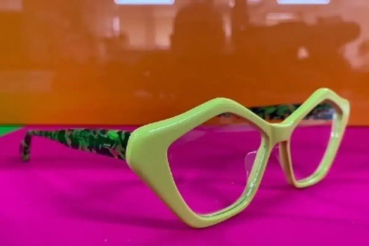 A pair of glasses featuring a vibrant green and yellow frame, showcasing a stylish and playful design.
