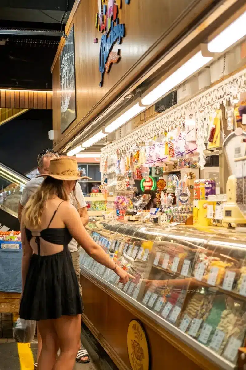 Woman browsing lolly shop.