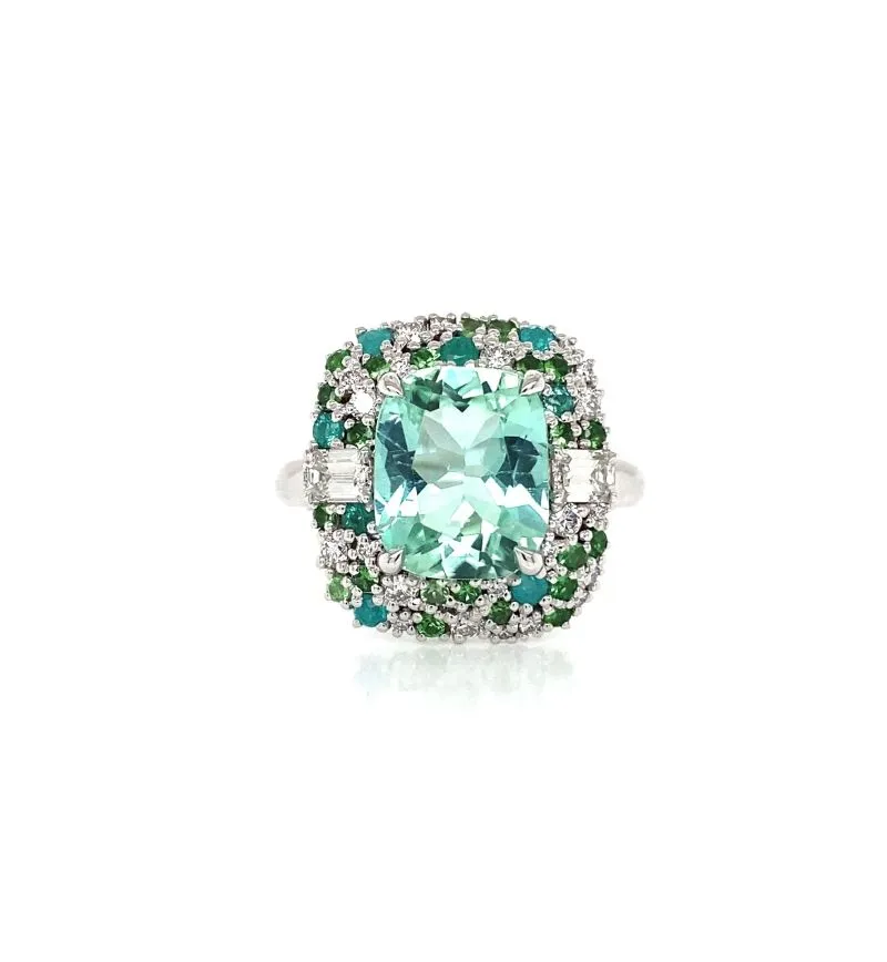 An elegant oval green and white diamond ring set in a polished band.
