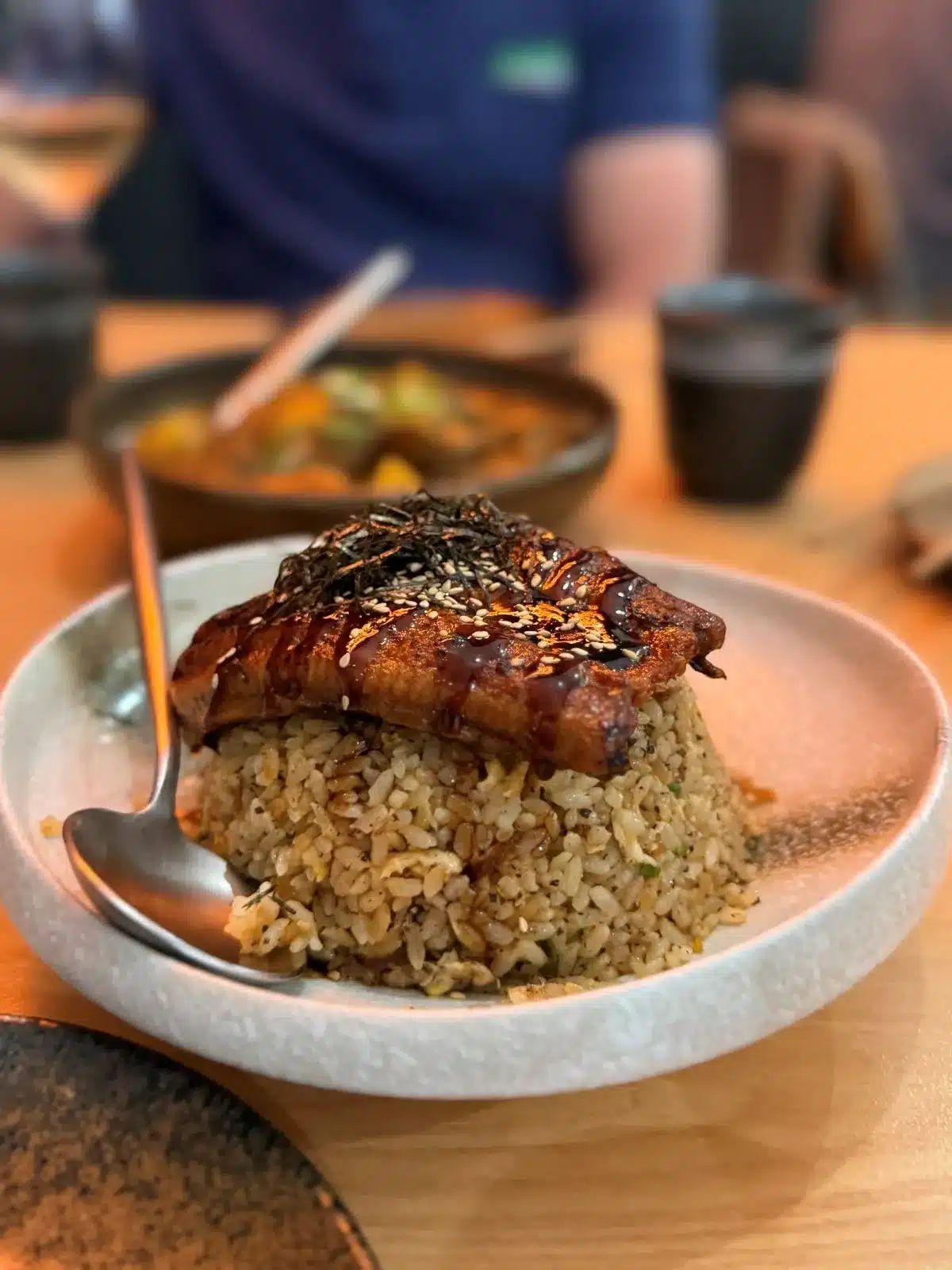 A plate filled with fluffy rice and tender pieces of meat, garnished for an appetizing presentation.