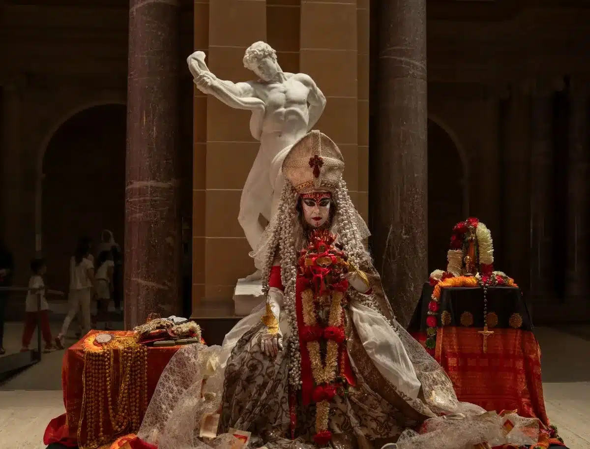 A statue of a woman in an elaborate costume, showcasing intricate details and artistic craftsmanship.
