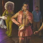 A diverse group of individuals in vibrant drag costumes, showcasing creativity and self-expression at a lively event.