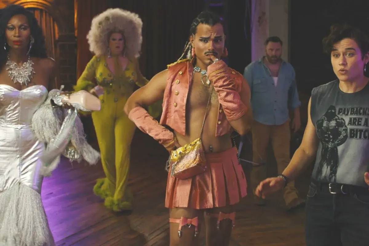 A diverse group of individuals in vibrant drag costumes, showcasing creativity and self-expression at a lively event.
