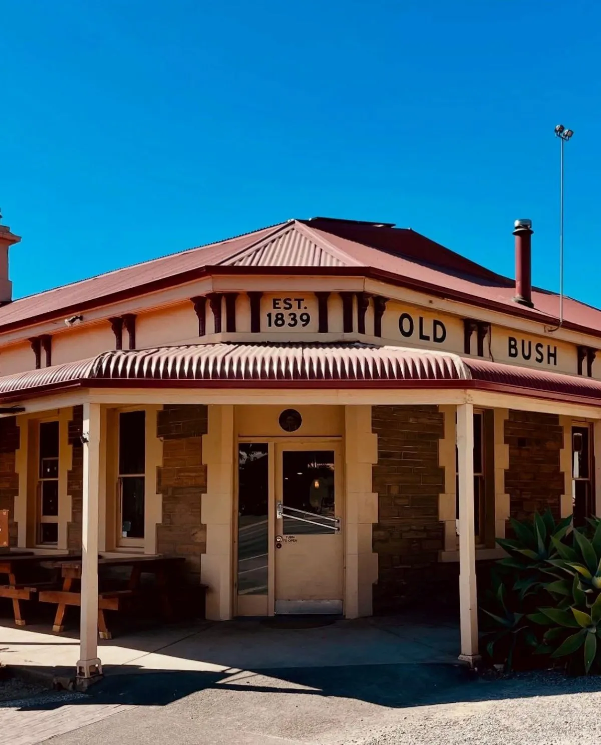 The Old Bush Inn's historic architecture and surrounding landscape.