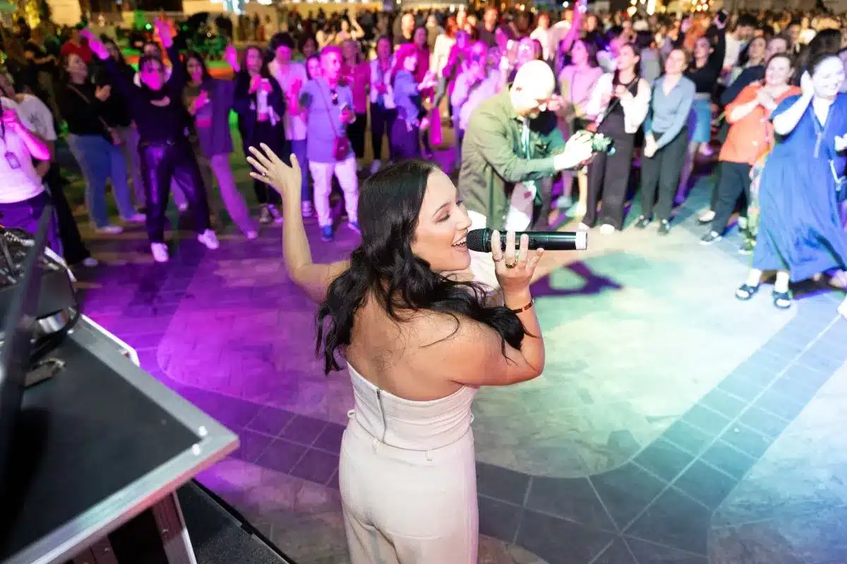 Woman sings to crowd.