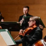 A group of musicians performing together on stage during a lively concert.