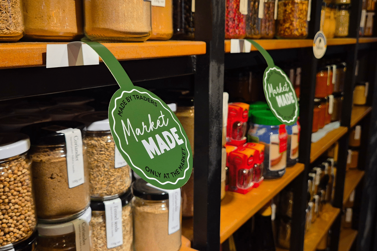A shelf displaying various jars of spices with the label 'Market Made'.