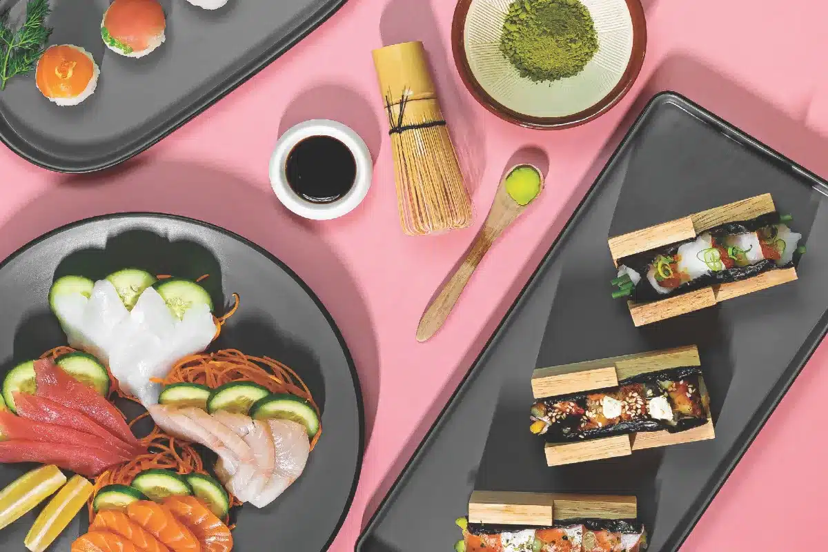 A table set with an assortment of sushi and various other dishes, showcasing a colorful and appetizing spread.