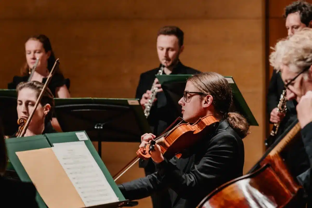 A group of musicians performing together on stage during a lively concert.