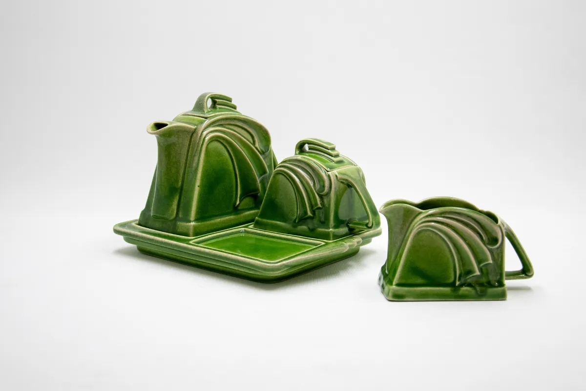 A green tea set featuring a tray and a pitcher, elegantly arranged for serving tea.