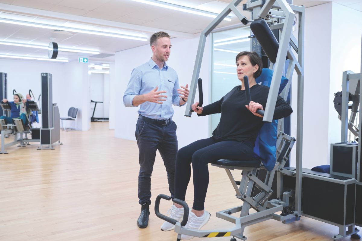 Kieser Glenelg Clinic Adelaide, woman works out with trainer. 