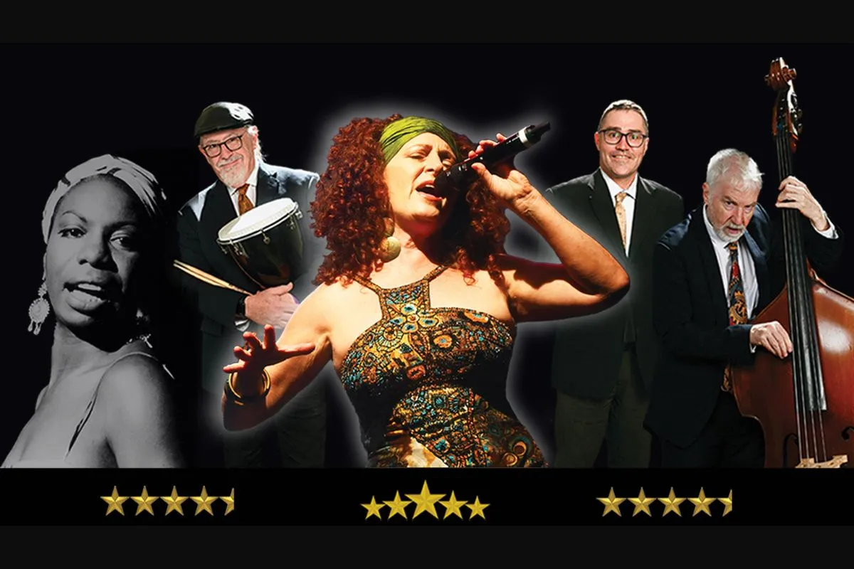 A woman dressed in gold sings passionately into a microphone performing with with musicians.