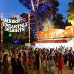 A fantastical garden venue brimming with crowds in an enchanting environment.