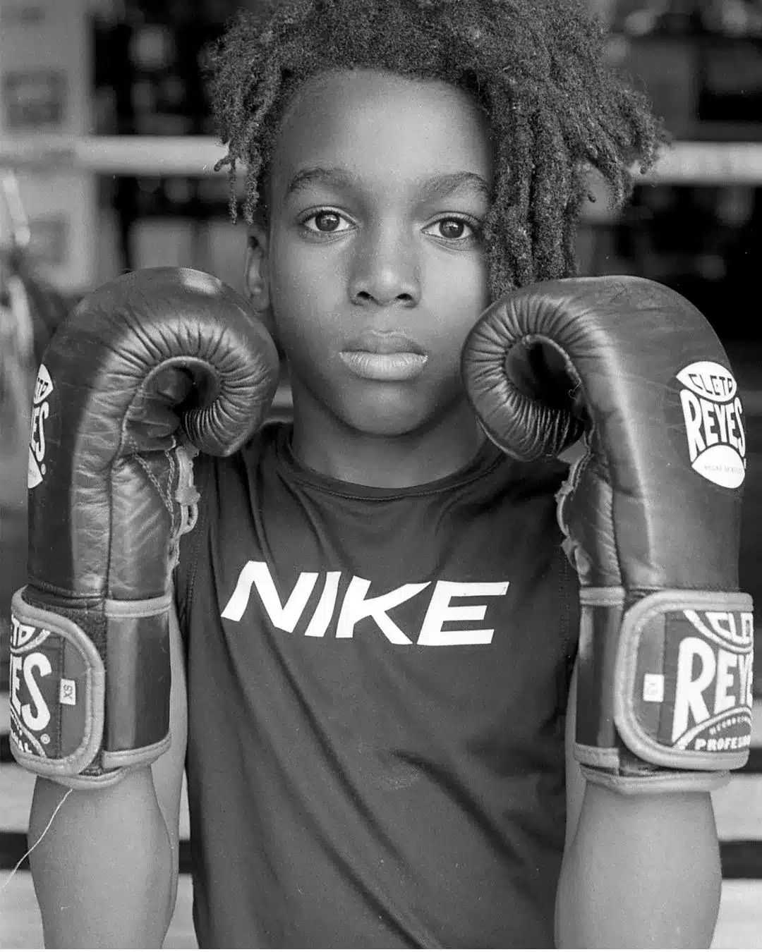 boy in boxing gloves and Nike t-shirt.
