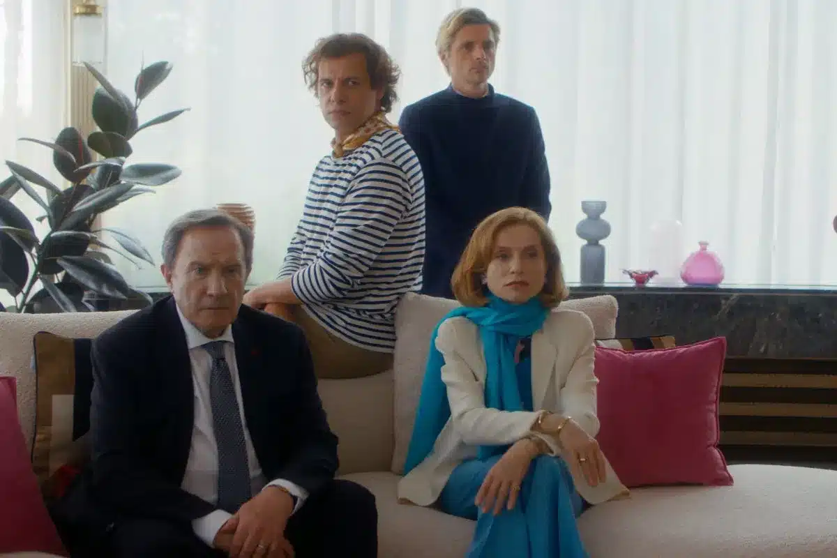 A wealthy and well dressed family sit on a sofa with serious expressions. The Richest Woman In the World (LA FEMME LA PLUS RICHE DU MONDE) - Allicance Francaise French Film Festival, Adelaide, South Australia.