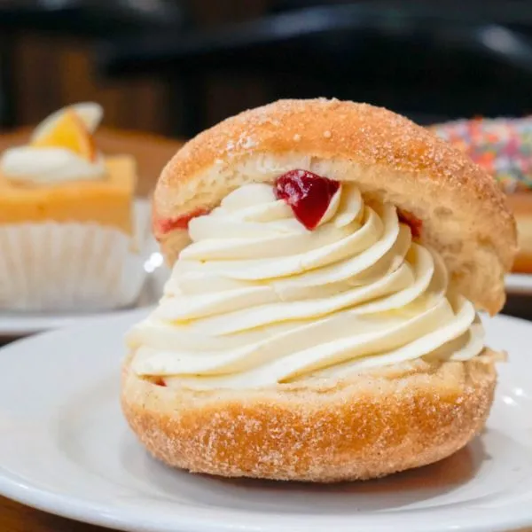 Kitchener bun - donut pastry filled with fresh cream and raspberry jam.