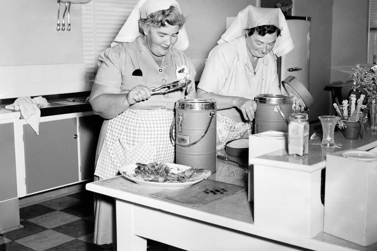 Meals on Wheels volunteers preparing food in the 1950s Adelaide.