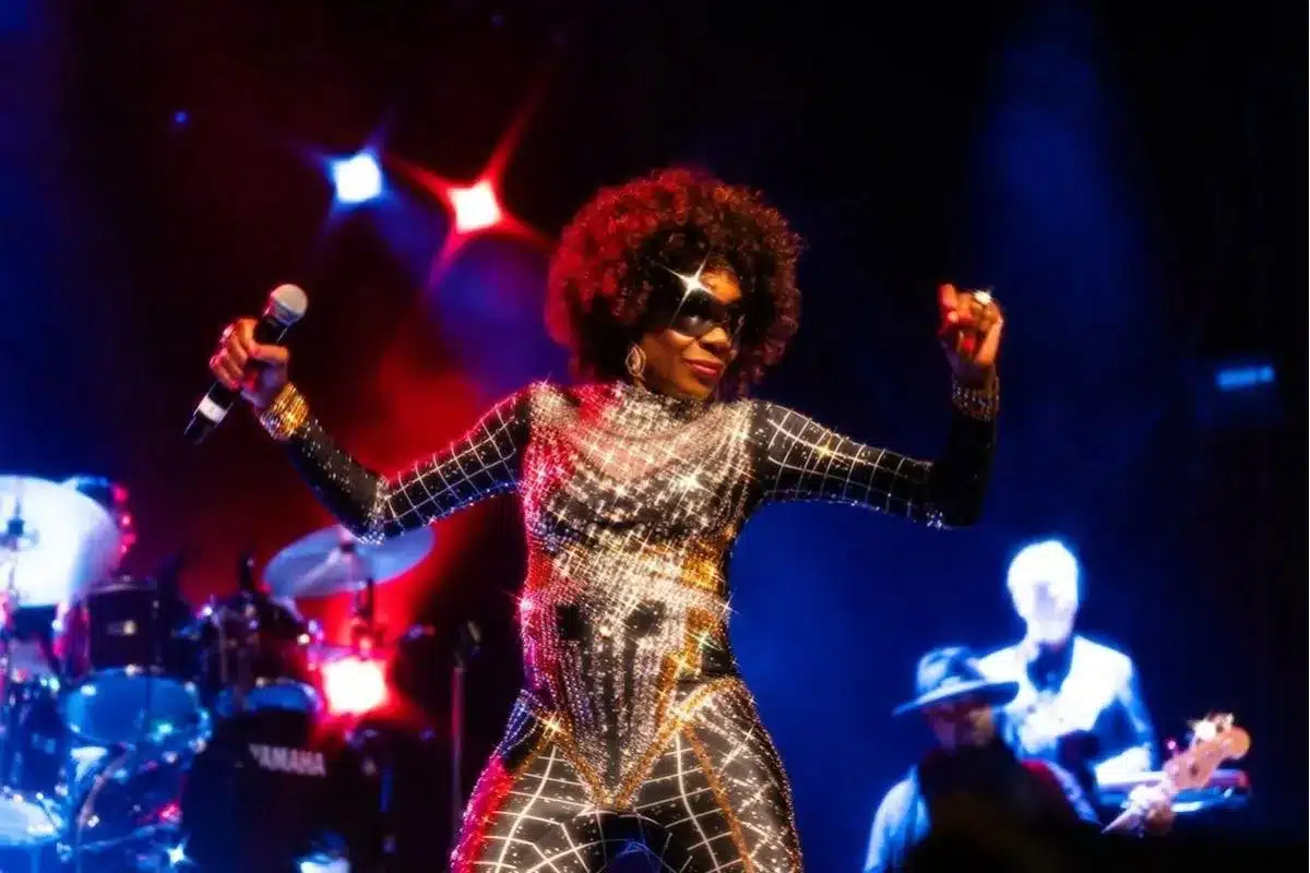 Boney M performer on stage in glittery outfit.