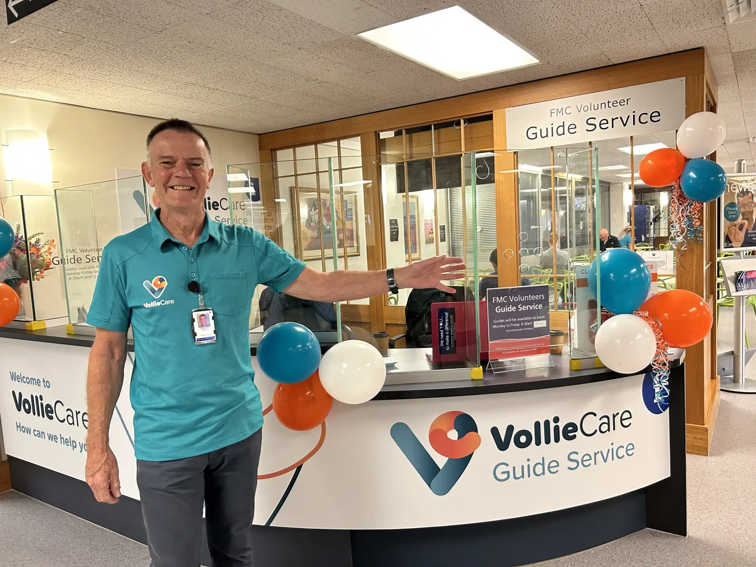 A volunteer smiles in the foyer of Vollie Care Guide Service. 