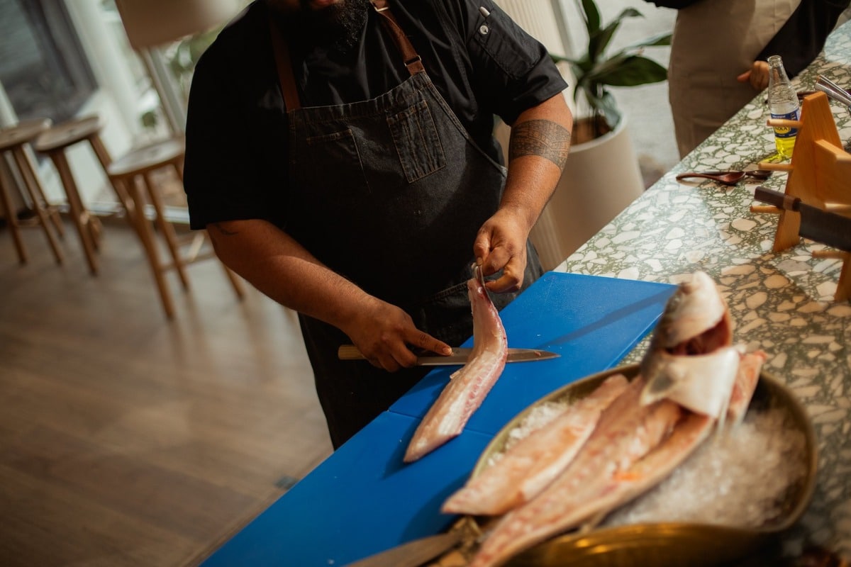 Chef Krish Dutt demonstrating fish preparation.