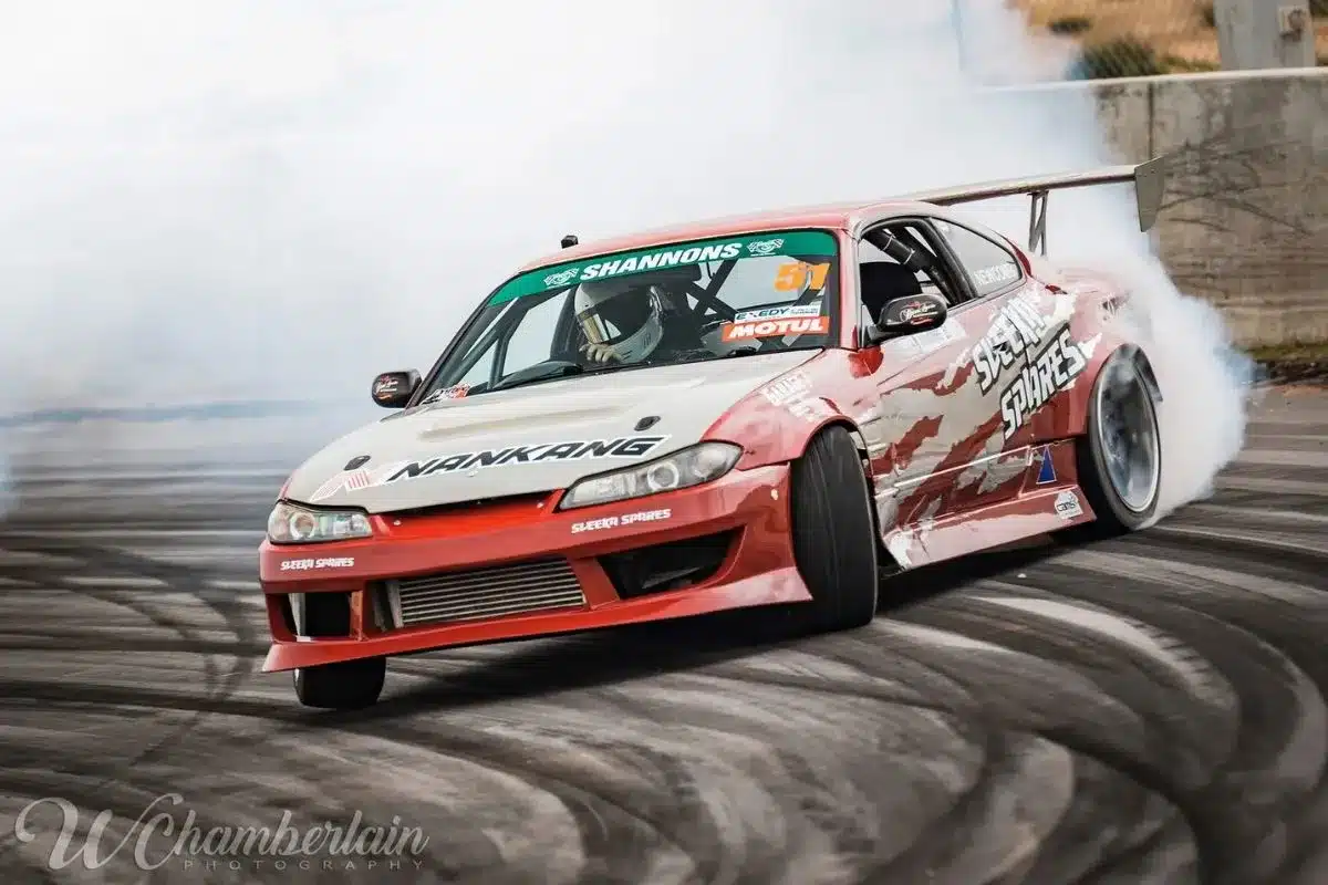 ASO - Australian Symphony Orchestra Dean Newcombe competitive drifting - red and white car.