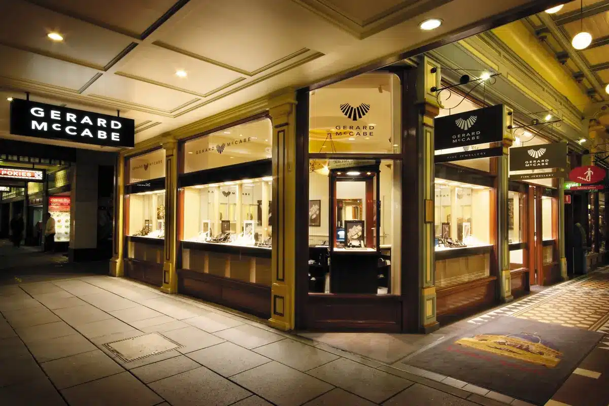 The Gerard McCabe fine jewellery store frontage in Adelaide Arcade, featuring illuminated display windows showcasing jewellery and watches, with the brand's signage prominently displayed.