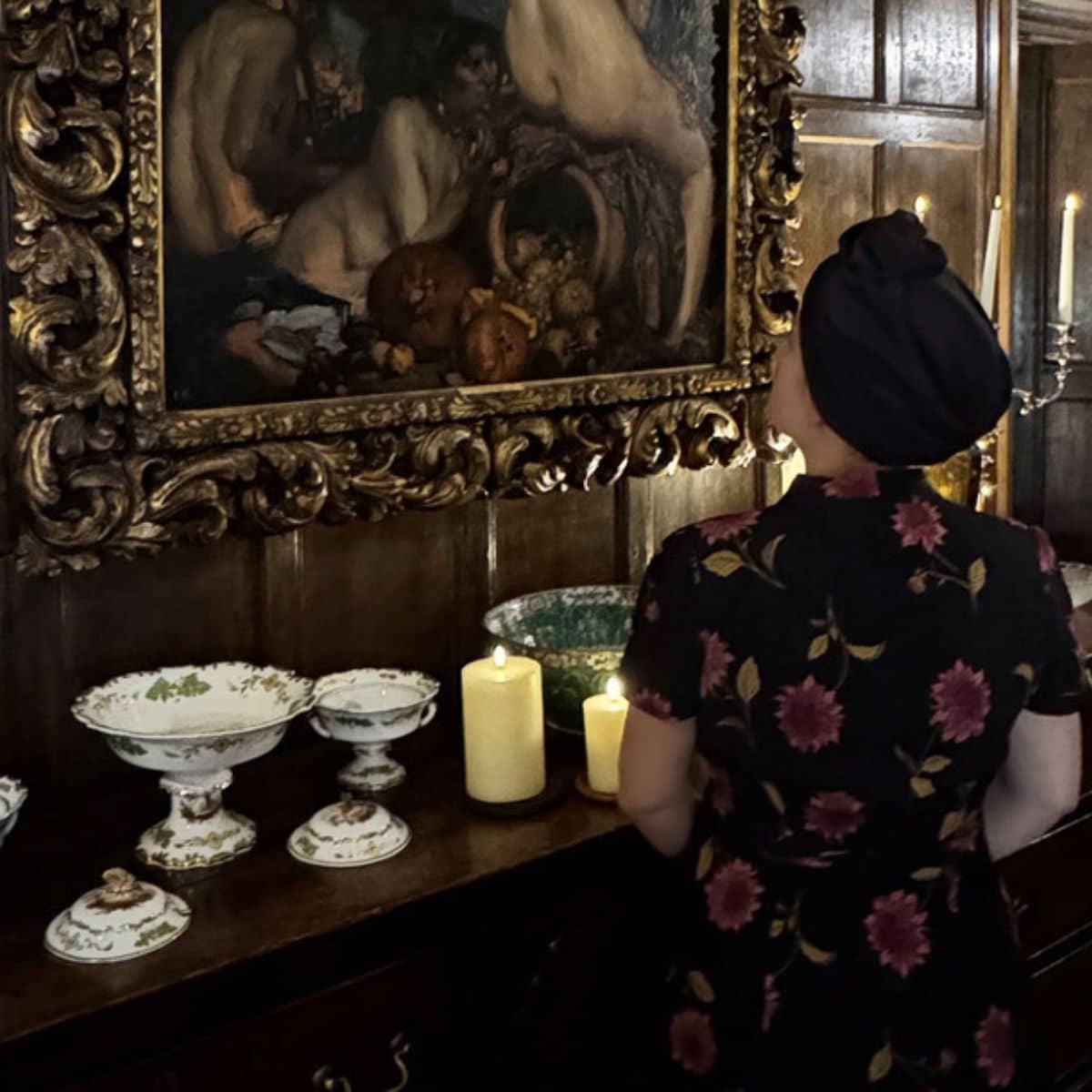 Carrick Hill a woman admires antiques and artworks on the walls.