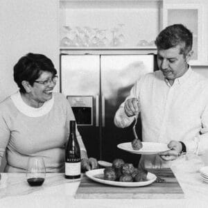 Mitolo Wines, Little Wolf Osterio Mothers Day - a mother and son sharing a meal together in a kitchen with a bottle of wine.