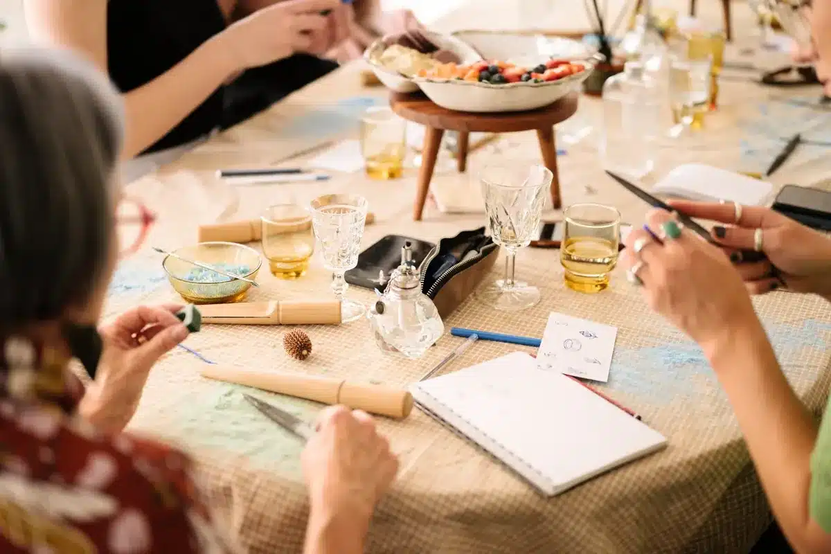 The Mill Creative Studio, Adelaide. A group of creatives sit around a table participating in a workshop.