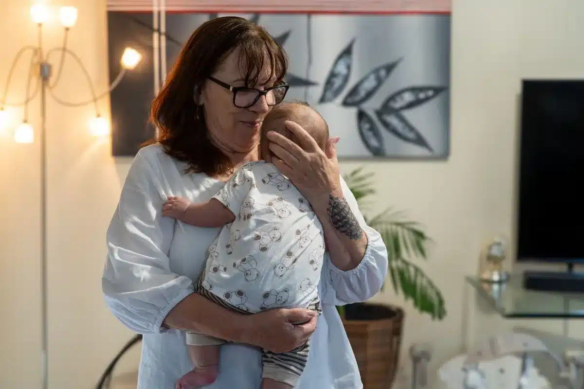 A woman holding a small baby.