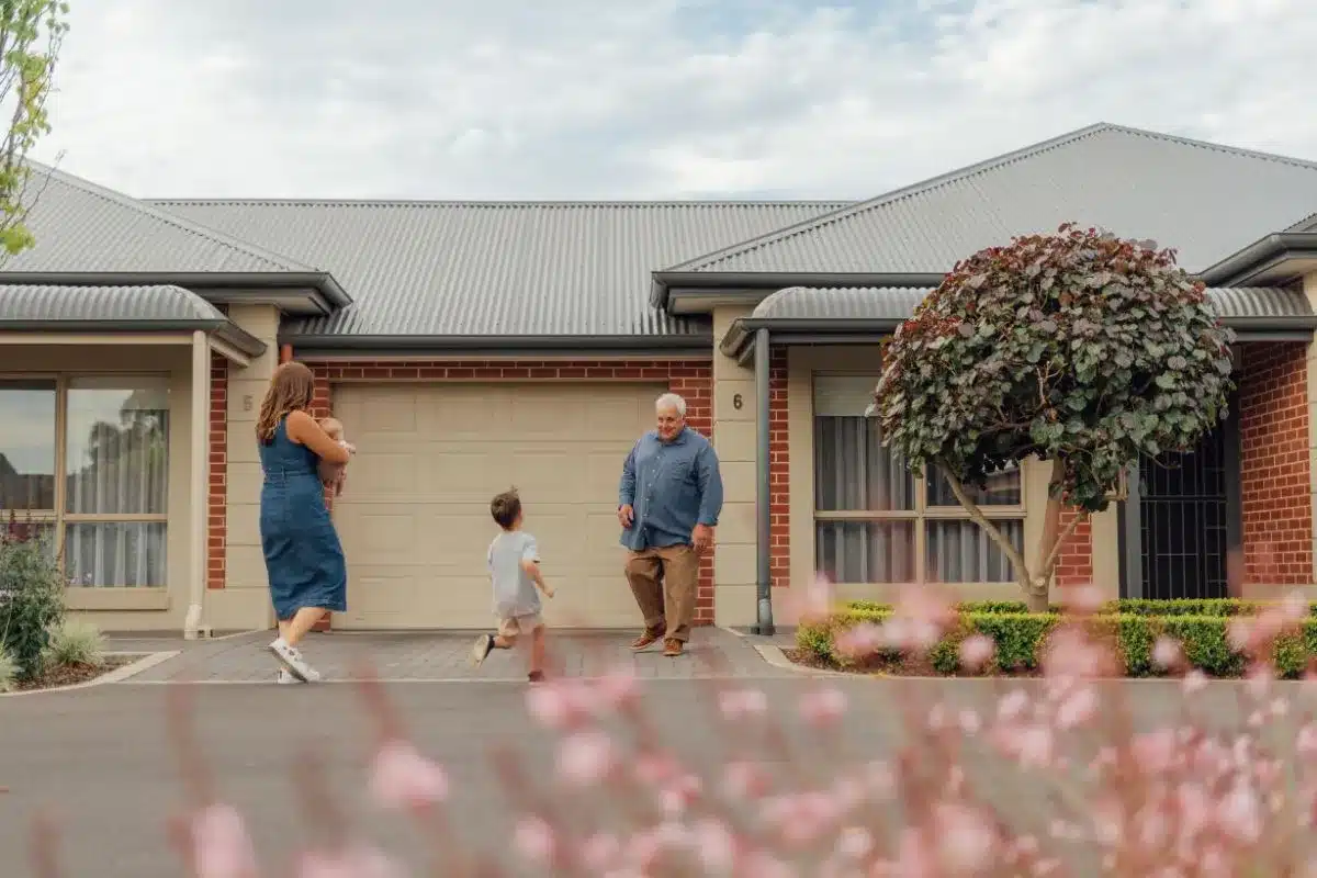 Grandparent spending time outdoors with grandchild at an ECH retirement village.