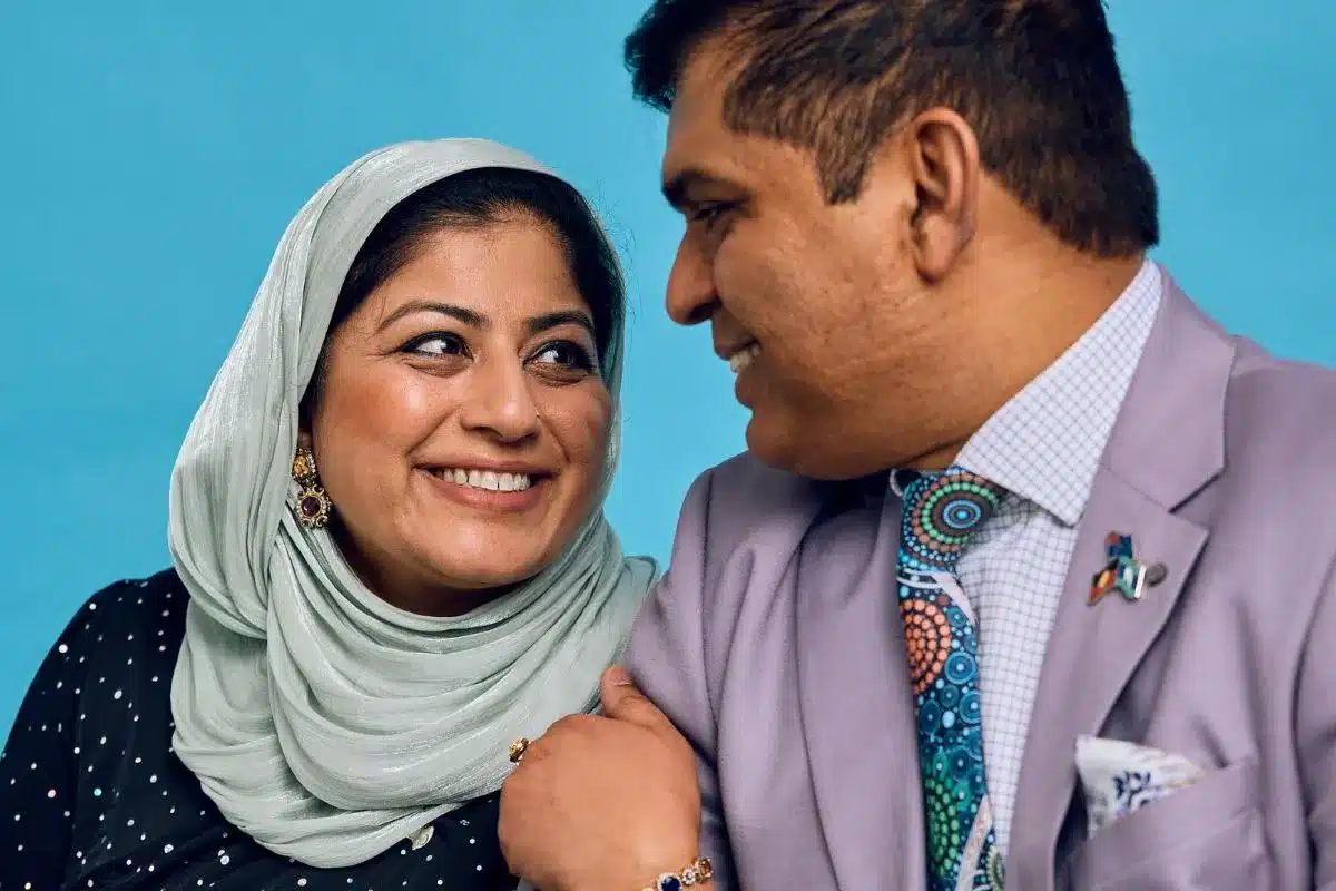 SA History Festival - Image of Sobia and Ifran Hasmi gasing lovingly into each others eyes dreassed in blue head scarfe and purple suit with an indigenous print tie.