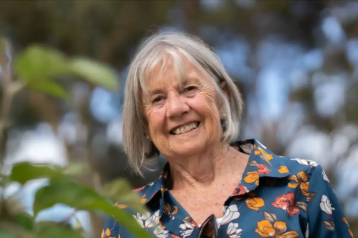 Crichton Court resident Mary Waite smiling in her garden