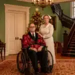 Peter Goers as Sheridan Whiteside in a wheelchair with his on-stage nurse in The Man Who Came to Dinner