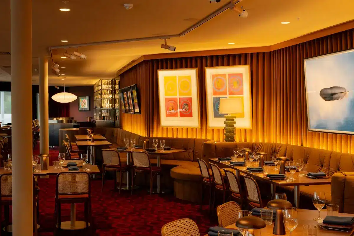 The entry foyer of Angry Penguin restaurant with deep red velvet curtains and a large framed painting