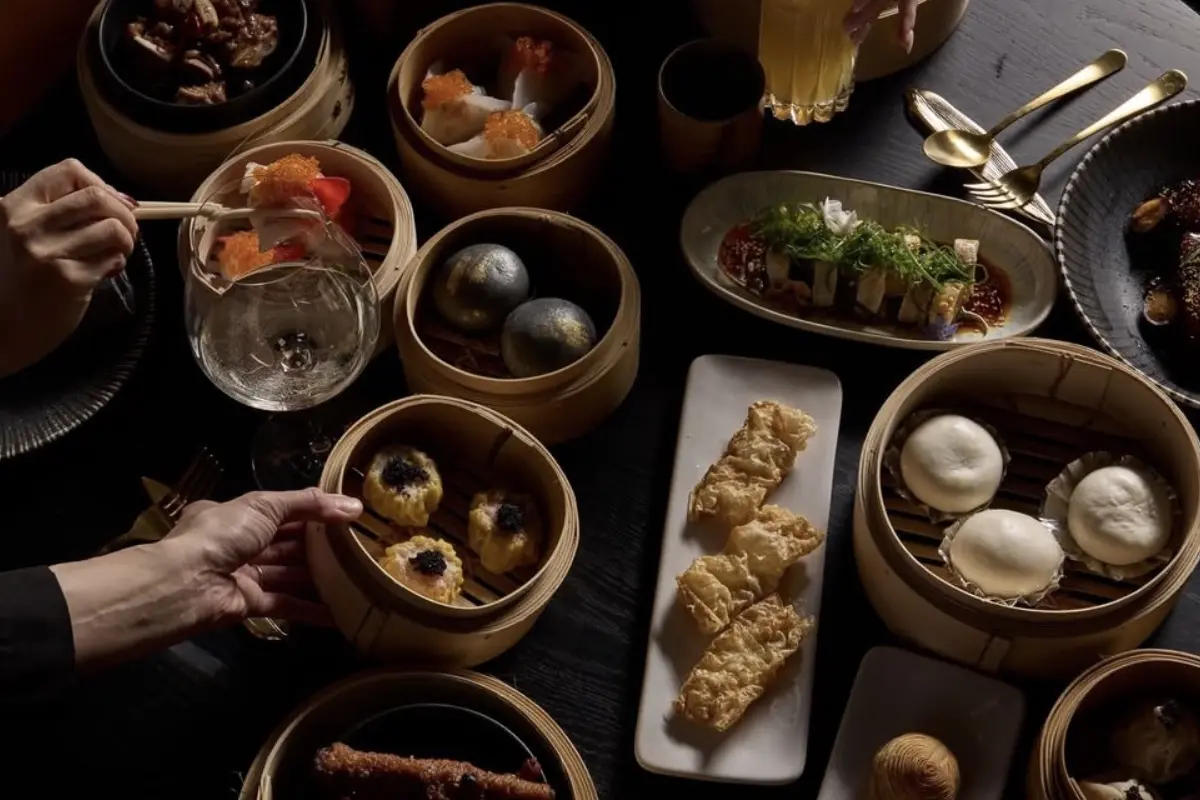 An overhead spread of bamboo dim sum baskets and share plates at Huami restaurant, SkyCity Adelaide