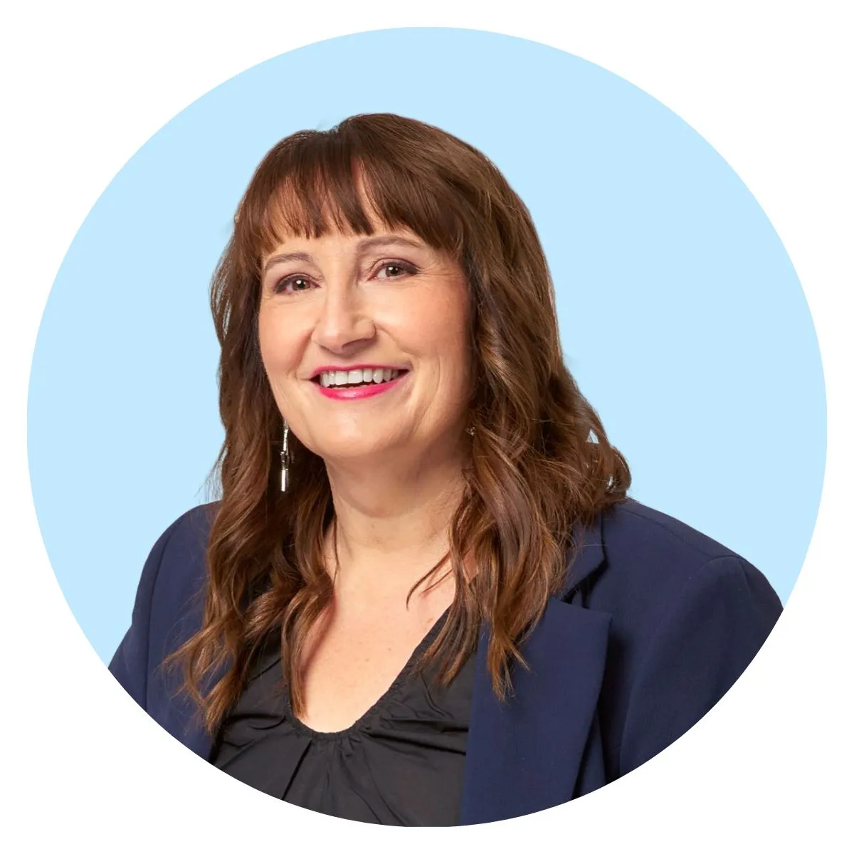 Angie McBride, FIVEAA Weekend Breakfast co-host, smiling in a navy blazer.
