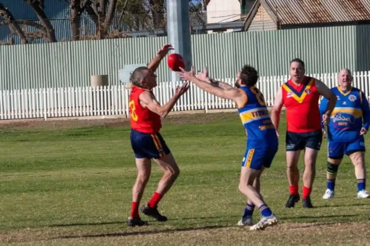 Riverland resident Robbie Johnstone contests a mark playing AFL Masters football at 83