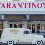Bold red hand-painted Tarantino's signage above the entrance, with the MoonDog signs van parked outside.